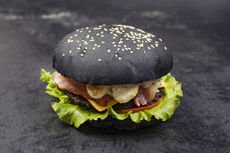 Delicious burgers of black dough with red fish on a beautiful slate boardの写真素材