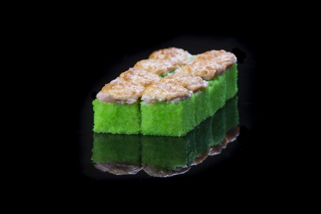 Sushi rolls with salmon, tuna, cucumber and green onions on black backgroundの写真素材