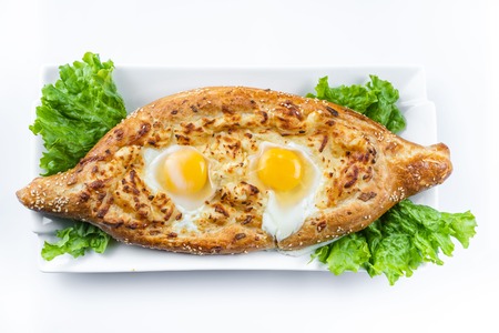 Khachapuri in Adjarian. Open pie with mozzarella and egg. Georgian cuisine.の写真素材