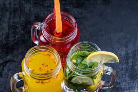 Lemonade or Mojito cocktail with lemon and mint, raspberry, sea buckthorn, grapefruit, cold refreshing drink or drink with iceの写真素材