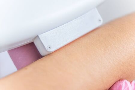 laser hair removal. Closeup of beautician hair removal hands of a young woman. Procedure Of Cosmetic Hair Removal In Cosmetic Beauty Clinic. Hairless Smooth And Soft Skin. body care. high resolutionの写真素材