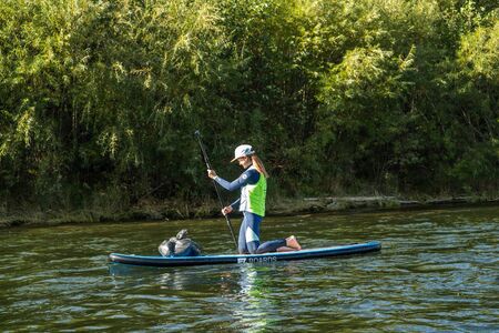 KHABAROVSK, RUSSIA - September 20, 2019 : Water tourists paddle SUP Stand up paddle board on the...