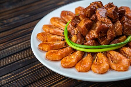 Overhead of dinner table. Barbecue meat and seafood with vegetable. Pork grilled steaks, grilled salmon trout, mussels, shrimps, dried tomato, cherry tomato, glass of wine. Picnic bbq party concept.の写真素材