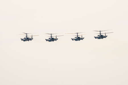 Russia, Khabarovsk - May 9, 2020: K-52 helicopters alligator fly in formation Parade in honor of victory. Military air parade in honor of Victory Day.のeditorial素材