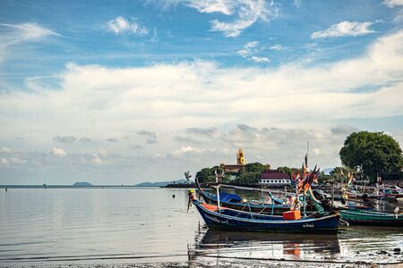 Fishing boats on the shore at low tide . Thailandの写真素材
