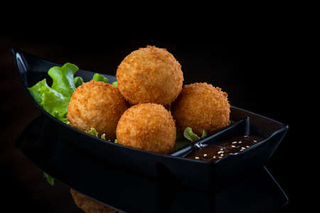 A box filled with different types of food. cheese ballsの写真素材