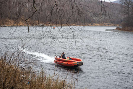 inflatable motor boat. fishing boat on a mountain river. Anyui River. Khabarovsk territory, far East, Russiaの写真素材