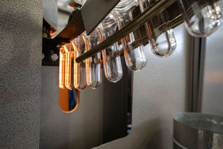 The various type of plastic bottle product and preform material with injection mold background....