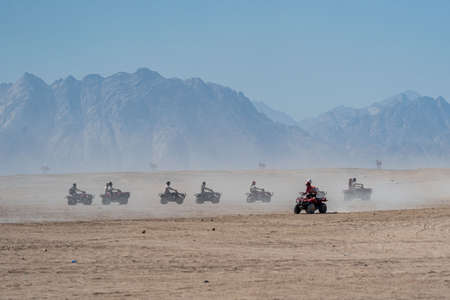 People driving quad bikes during safari trip in Arabian desert not far from Hurghada city, Egyptの写真素材