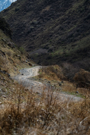 Gravel road and landscape in Shamsi gorge . Kyrgyzstan