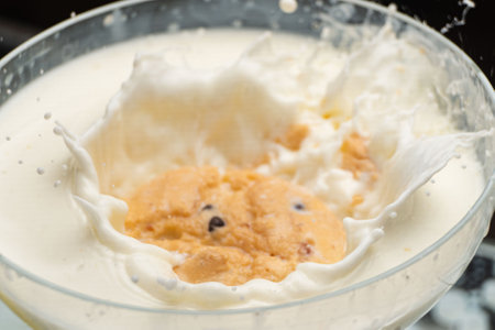 Chocolate Chip Cookie falling and splashing in milk.の写真素材
