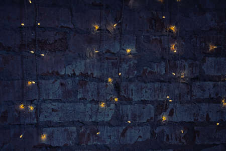 Eelectric garland on dark brick wall background