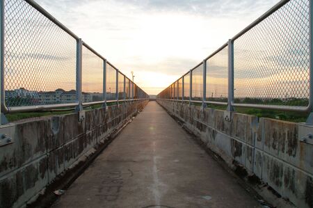 Sunrise at Bridge for people across the street.の写真素材