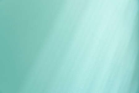 Light and shadow on blue wall for backgroundの写真素材