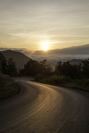 Sunrise on the road on the mountain.の写真素材