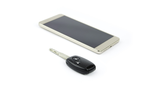 Remote car key and mobile phone on isolated background.の写真素材