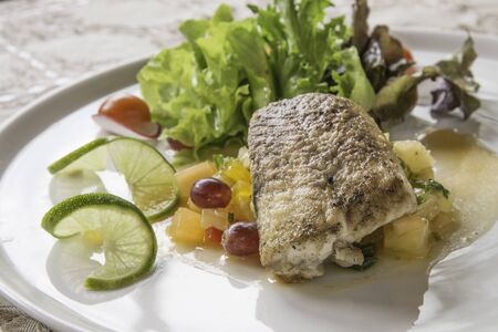 Grilled Sturgeon with salsa sauce salad.の写真素材