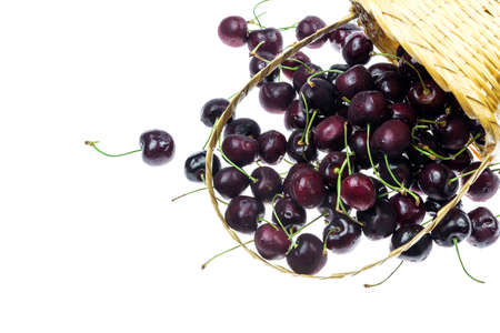 Cherry fruit in bamboo basket on isolated background.