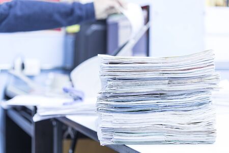 stack of documents on desktop in office.の写真素材