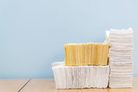 stack of documents on desktop in office.