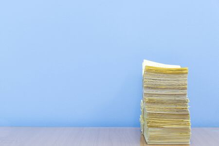 stack of documents on desktop in office.