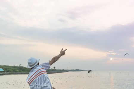 The man who will enjoy to playing with a seagull.の写真素材