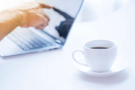 Cup of coffee and modern touch screen notebook.の写真素材