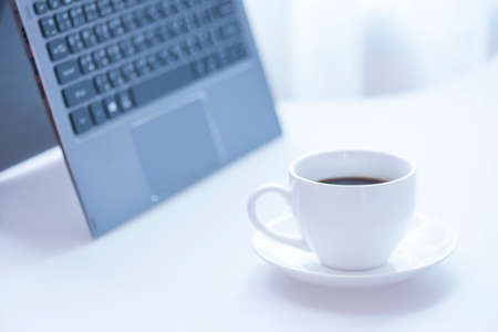 Cup of coffee and modern touch screen notebook.の写真素材