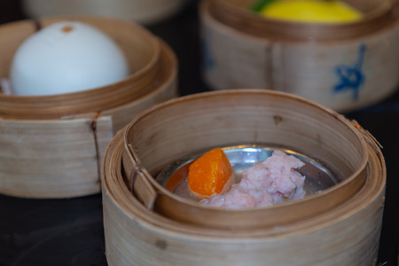 Variety of dim sum steamed in bamboo basket. Chinese breakfast style in southern of Thailand.の写真素材