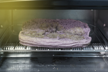 Electric micro oven grill purple sweet potato bread and butter.の写真素材
