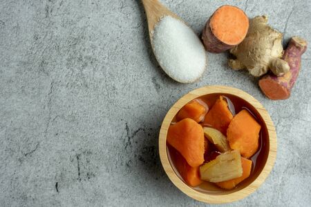 Sweet Potato Orange in Ginger Syrup on cement background, Dessert. Top viewの写真素材