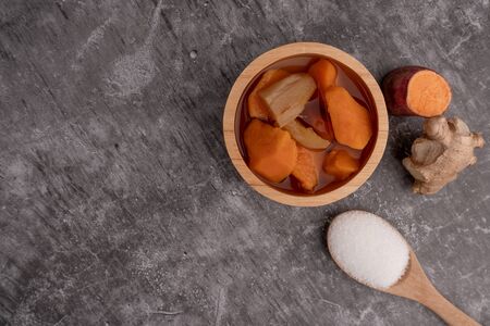 Sweet Potato Orange in Ginger Syrup on dark cement background, Dessert. Top view.の写真素材