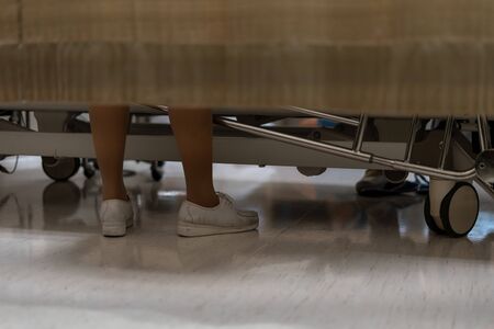 Legs of nurse behind the curtains in the hospital room. Patient service.の写真素材