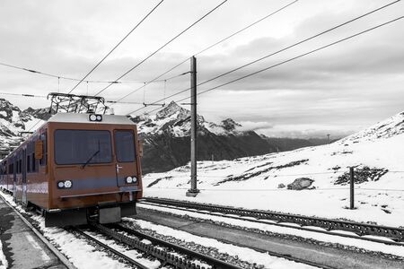 Electric train and railway (cogwheel) on snowy for traveling around Matterhorn mountain.
