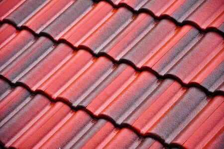 Red and black roof-tiles on the rainy dayの写真素材