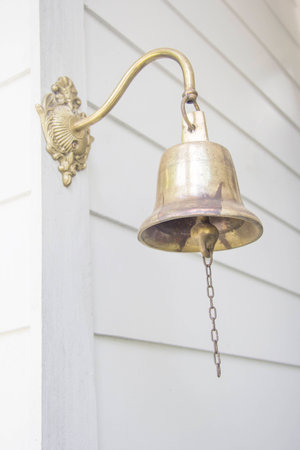 Old bell in front the houseの写真素材