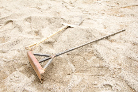 Shovel and Harrow on the sandの写真素材