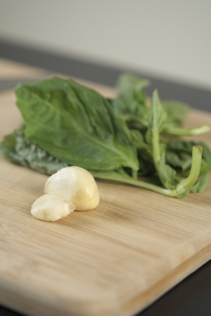 garlic, and basil on chopping blockの写真素材