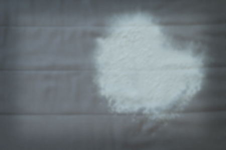 Blurry white heart on grey fabricの写真素材