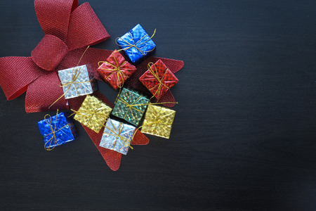 colorful gift box and bow on black wood table