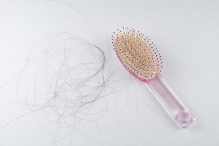 Blurry of Hair fall in pink comb everyday serious problemの写真素材