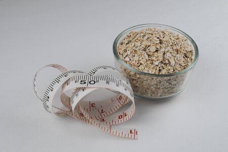 oatmeal bowl with tape on white backgroundの写真素材