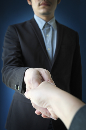 a man shaking hand with a personの写真素材