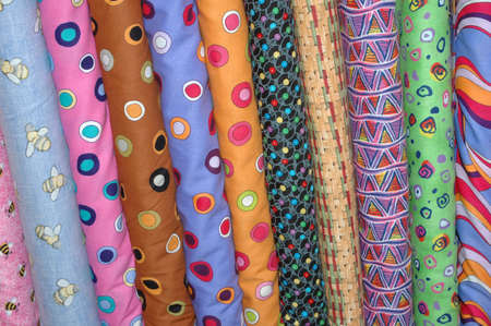 Colorful bolts of quilting fabric.
