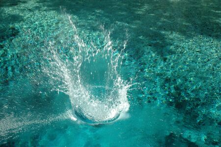 A swimmer splashes into the crystal clear water of Blue Spring in High Springs, Florida.の写真素材
