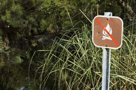 A sign warns campers not to build a campfire in the creek.の写真素材