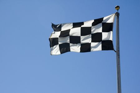 A finish line flag on a pole at a raceway.の写真素材