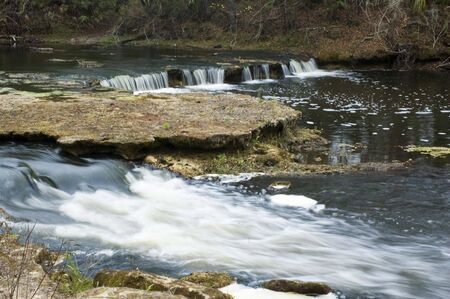 Low water flow on Steinhatchee Falls makes for a dramatic view of the limerock bed.の写真素材