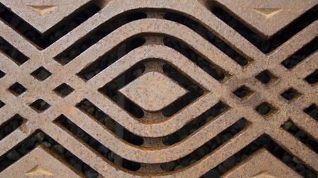 A rusty metal grate with a modern pattern.の写真素材