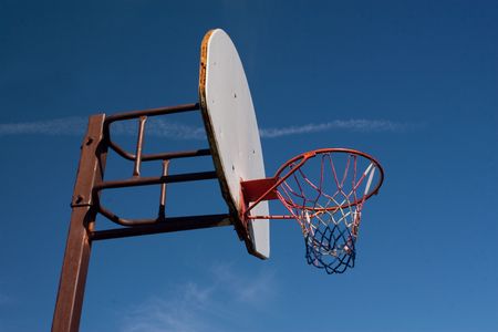 An American red-white-and-blue Basketball Hoop Against a Blue Sky